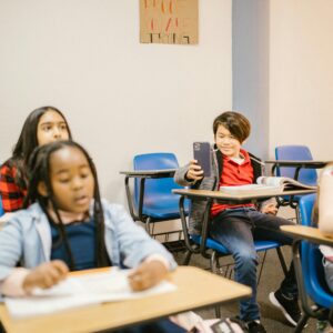 Students in a classroom using technology, fostering education and interaction.