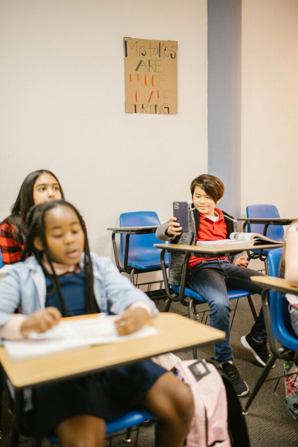 Students in a classroom using technology, fostering education and interaction.